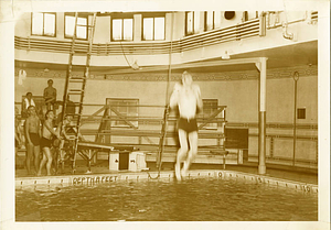 Student jumping into McCurdy Natatorium