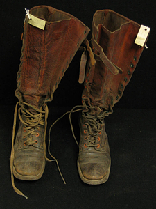 Charles White Whittlesey: Brown high leather boots with laces and buckles at top - Front